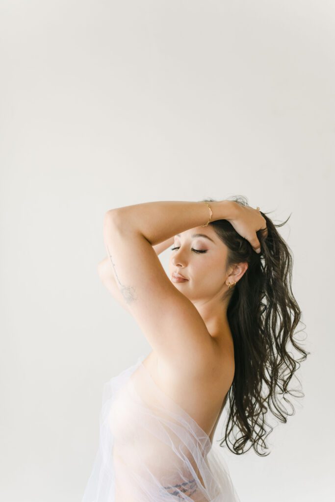 Luxury boudoir photography in Atlanta GA featuring bride wrapped in veil.